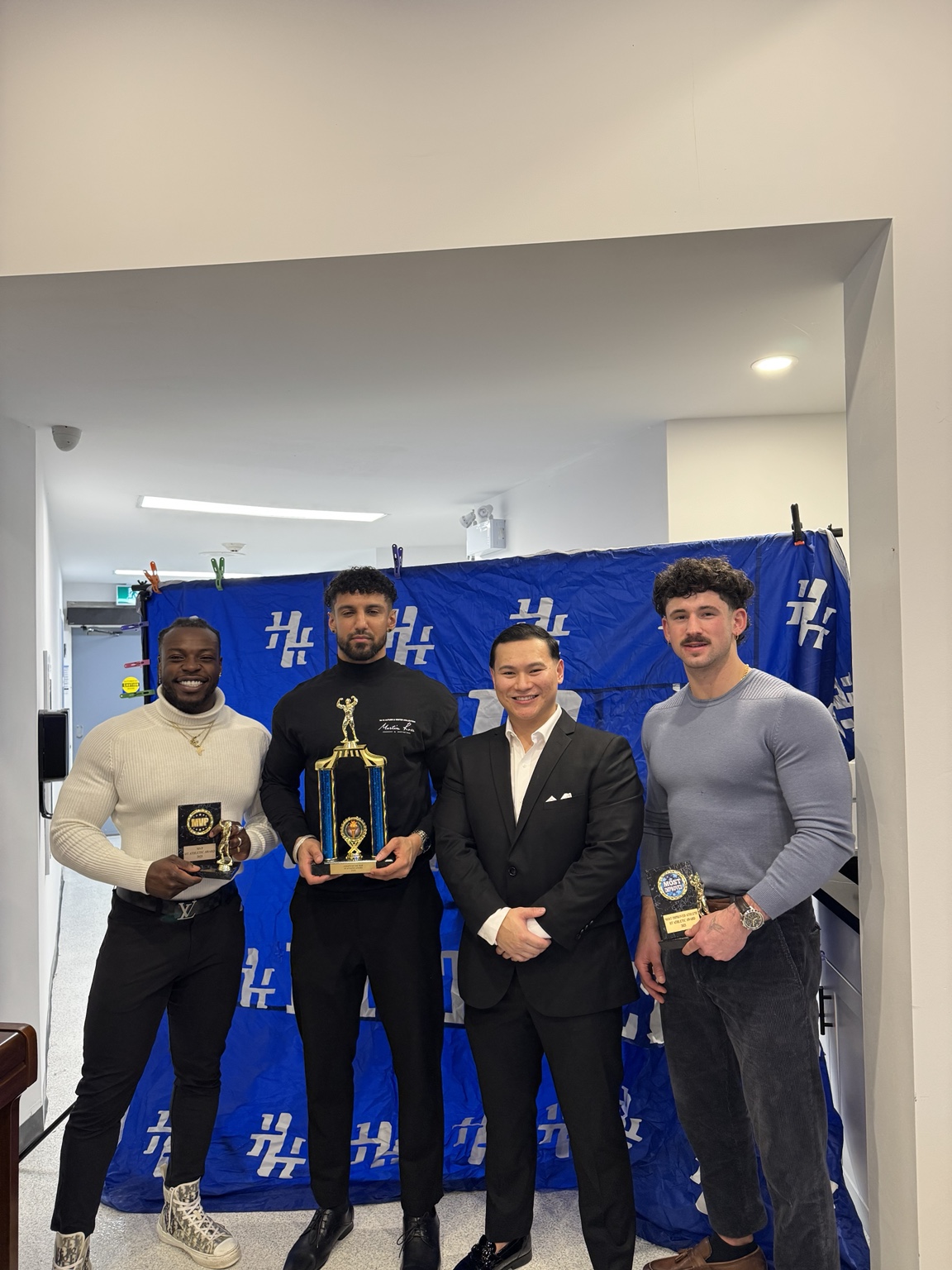 Guests posing with awards at an HT Athletic event