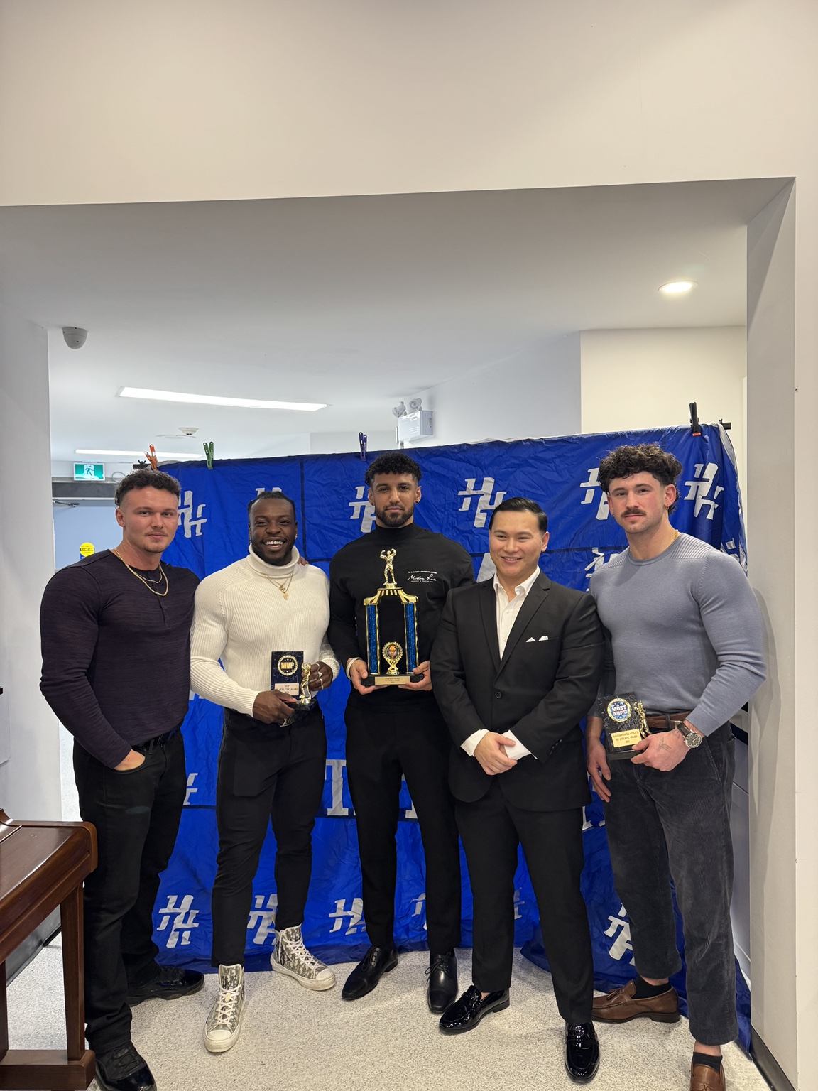 Group posing with trophies at an HT Athletic event