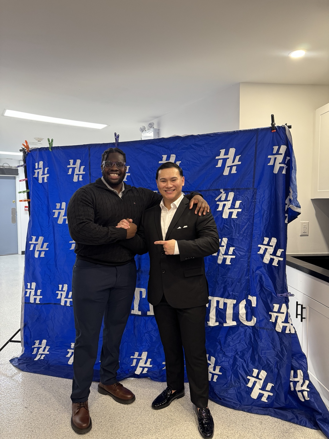 Two guests posing with an award